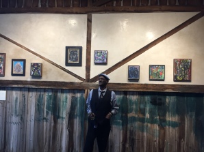 Emery Williams with his paintings