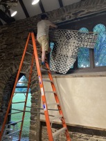 Alex Cohen installing Alyssa Sakina Mumtaz' work in the chapel
